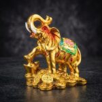 Feng Shui Elephant Standing On Lucky Coins & Ingot Showpiece in Resin (Golden) (9 Cms)